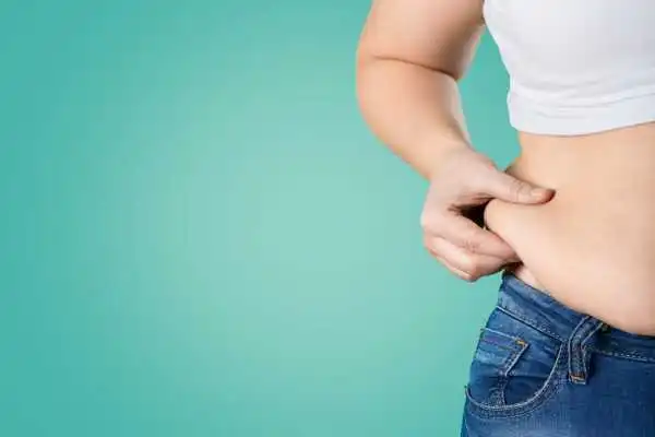 Image of woman pinching her love handles to show weight gain Ryton on Dunsmore